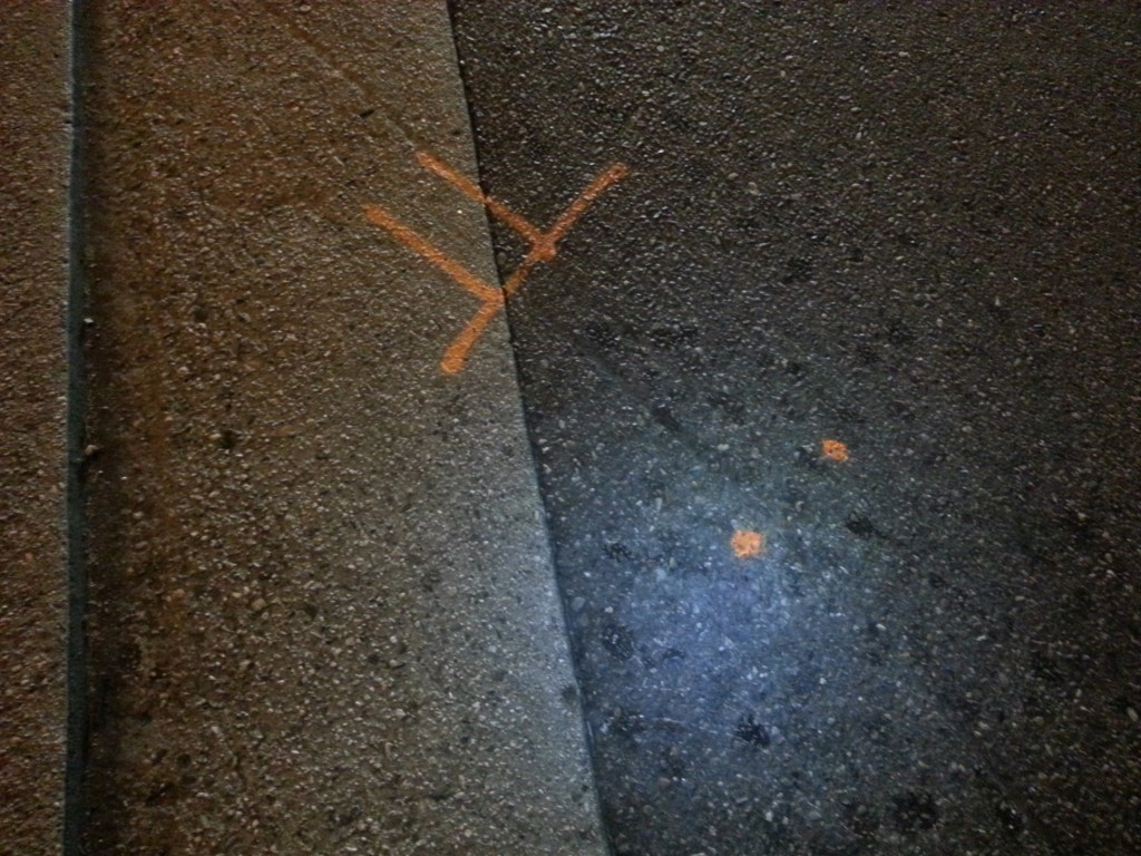 Groove carved in pavement by dragging bike under truck; photo by Danny Gamboa.